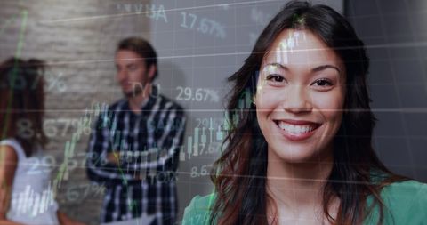 Smiling businesswoman overlaid with finance charts digital composite