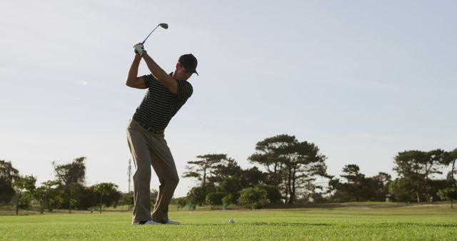 Male Golfer in Mid-Swing on Sunny Golf Course - Download Free Stock Images Pikwizard.com