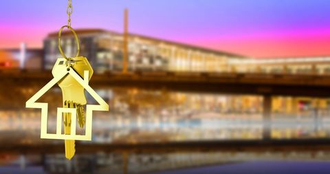Golden House Keys on Cityscape Background