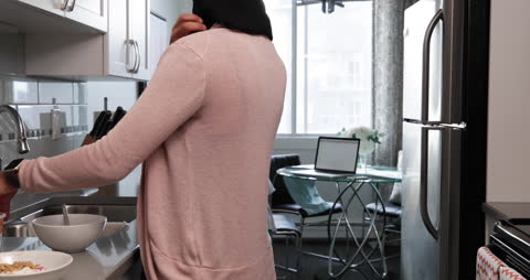 Mother and Daughter Busy in Modern Kitchen Setting