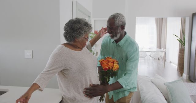 Happy Older Couple Celebrating with Flowers at Home - Download Free Stock Images Pikwizard.com