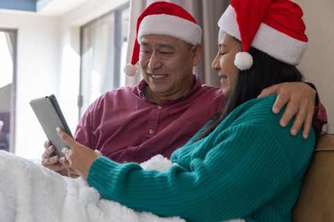 Couple in Santa Hats Enjoying Holiday Moments Together