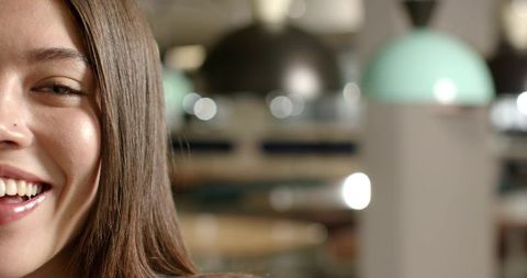 Smiling african american woman with nose stud in cozy cafe closeup, urban coffeehouse portrait