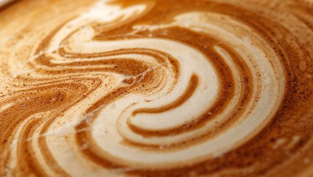 Caffeinated art: intricate milk foam marbling on latte