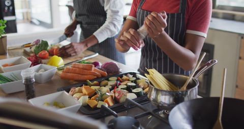 Diverse friends enjoy cooking fresh meal together