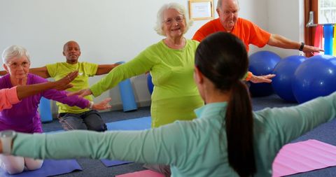 Seniors Engaged in Active Stretching Exercise Class
