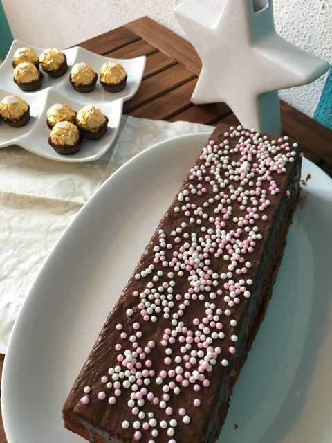 Chocolate Cake with Sprinkle Decoration and Ferrero Rocher on Table - Download Free Stock Photos Pikwizard.com