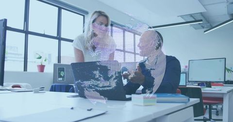 Collaborating over laptop with holographic globe overlay in bright modern office