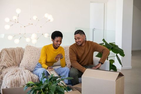Couple Unpacking Boxes in Bright and Minimalist Living Room