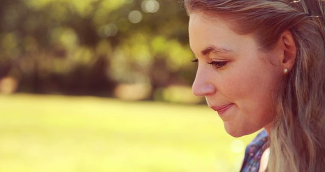 Smiling Young Woman Enjoying Sunny Day Outdoors in Park - Download Free Stock Images Pikwizard.com