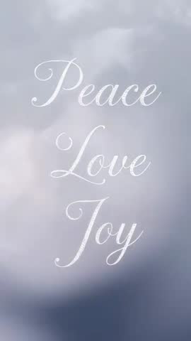 Vertical looping greeting video featuring white cursive Peace Love Joy on soft gray bokeh background