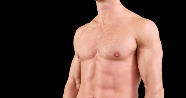 Shirtless muscular male torso against black background emphasizing fit physique, strength, and defined abs. Ideal for use in fitness promotions, health magazines, gym advertisements, and bodybuilding articles.