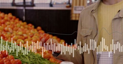 Man selecting fresh tomatoes at supermarket produce section