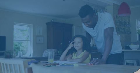 Supportive African American Adult Assisting Biracial Child at Home
