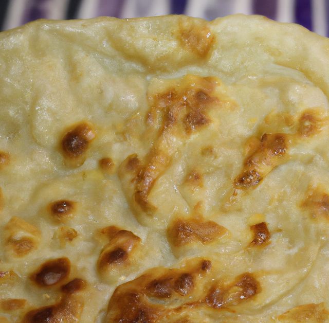 Close up of flat slices of baked roti bread on blurred background. Food, tradition and bread concept.