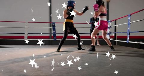 Female boxers sparring in ring with white star graphics, energetic training action