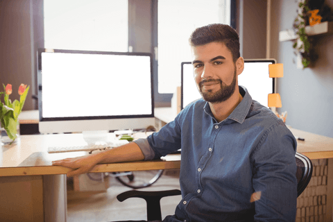 Confident Young Designer in Modern Office with Transparent Computer Screens - Download Free Stock Videos Pikwizard.com