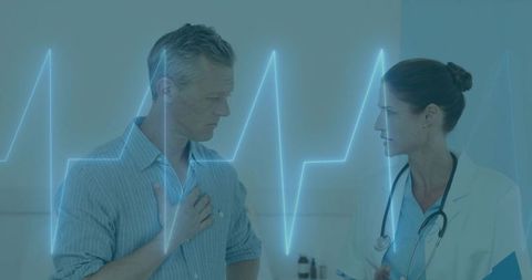 Doctor Assisting Patient with Heart Concerns and ECG Display