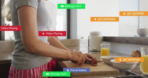 Woman Cooking in Modern Kitchen with Digital Notifications
