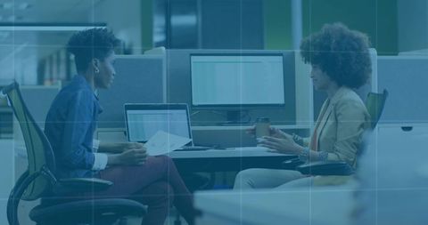 Colleagues exchanging feedback in modern professional workspace