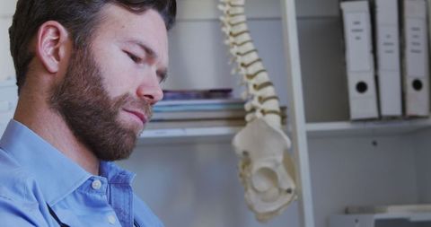 Male Doctor Consulting at Medical Office with Technology