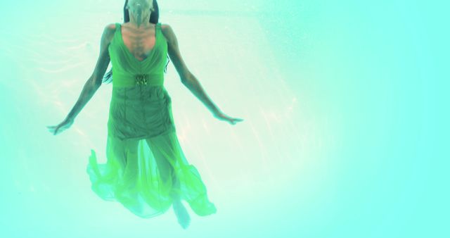 Woman in Green Dress Underwater Floating Gracefully - Download Free Stock Images Pikwizard.com