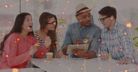 Diverse team collaborating on digital project with networking overlay