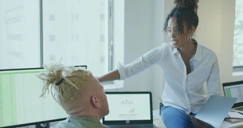 Business Associates Analyzing Data in Office Setting