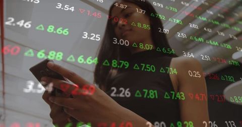 Businesswoman analyzing stock market data on glass display