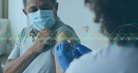 Elderly man receiving vaccine with digital data illustration