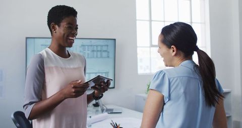 Two Diverse Businesswomen Collaborating in Modern Office Space