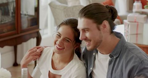 Smiling couple embracing at celebration gathering