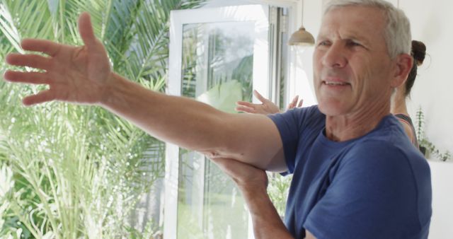 Senior Man Stretching Arms Preparing for Exercise at Home - Download Free Stock Images Pikwizard.com