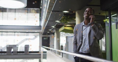 Businessman Talking on Smartphone in Modern Atrium