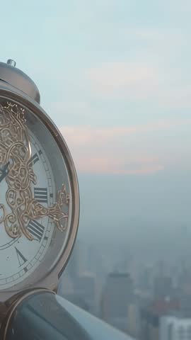 Rotating ornate clock revealing Roman dial and gold hands on rooftop railing at dawn cityscape