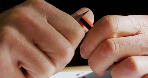 Hands removing bandage from finger with care