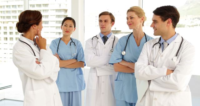 Medical team looking at camera and each other at the hospital