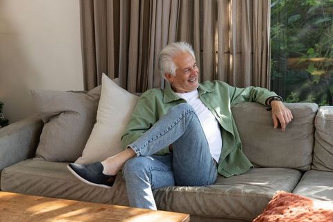 Senior Man Relaxing on Sofa in Cozy Living Room