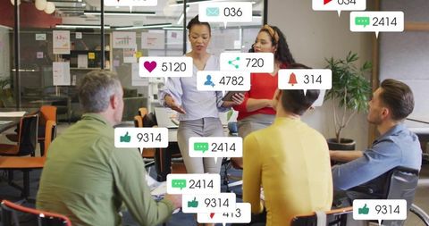 Presenting woman leading creative team meeting with social media engagement icons