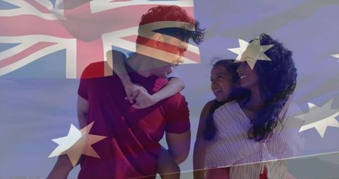 Laughing family celebrating australia on sunny beach with flag overlay double exposure