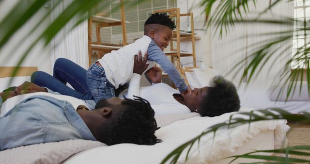 Happy African American Family Playing on Bed at Home - Download Free Stock Images Pikwizard.com