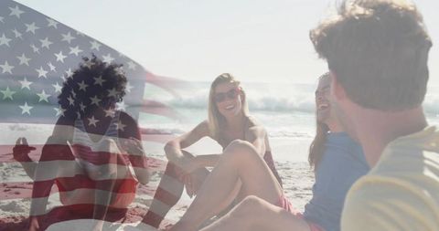 Friends enjoying patriotic beach gathering with faded american flag overlay