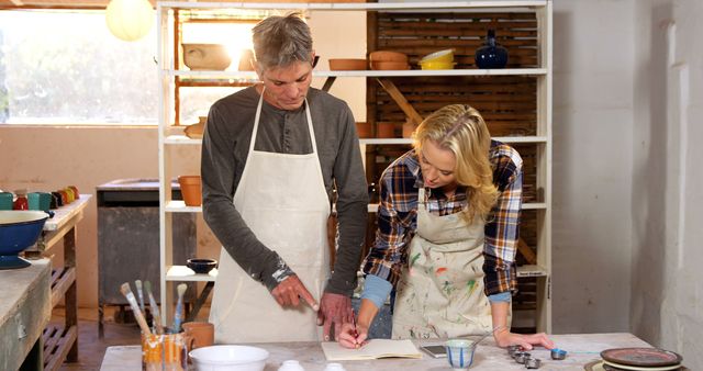 Senior Man Teaching Young Woman Pottery - Download Free Stock Images Pikwizard.com