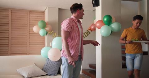 Friends celebrating birthday with delicious snacks at cozy home