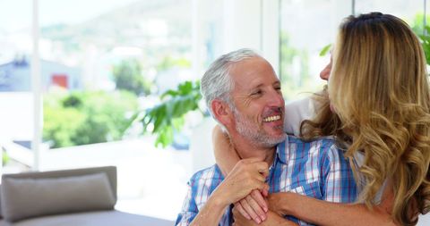 Happy Mature Couple Embracing Indoors with Bright Background - Download Free Stock Images Pikwizard.com