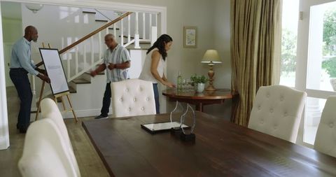 Diverse Seniors Preparing Living Room for Celebration