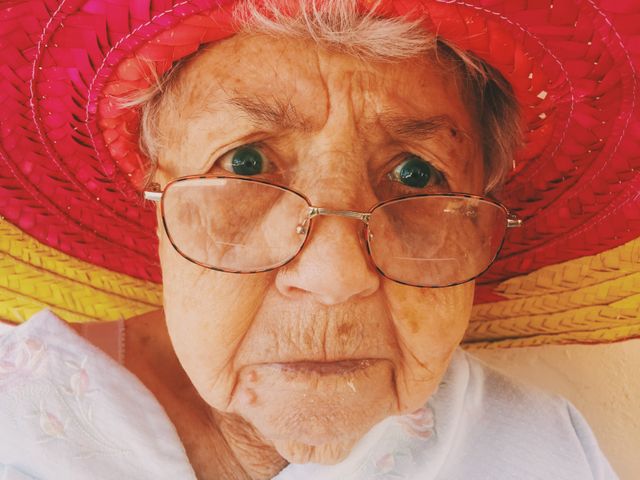 Elderly Woman with Glasses Wearing Colorful Hat - Download Free Stock Photos Pikwizard.com