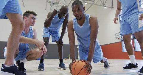 Basketball Team Training Indoors with Focused Players