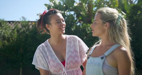 Diverse Friends Conversing in Backyard Garden Setting