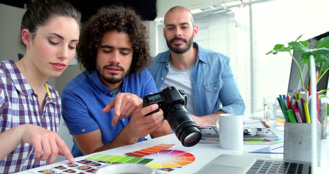 Creative Team Analyzing Photo Quality in Modern Office Studio - Download Free Stock Images Pikwizard.com